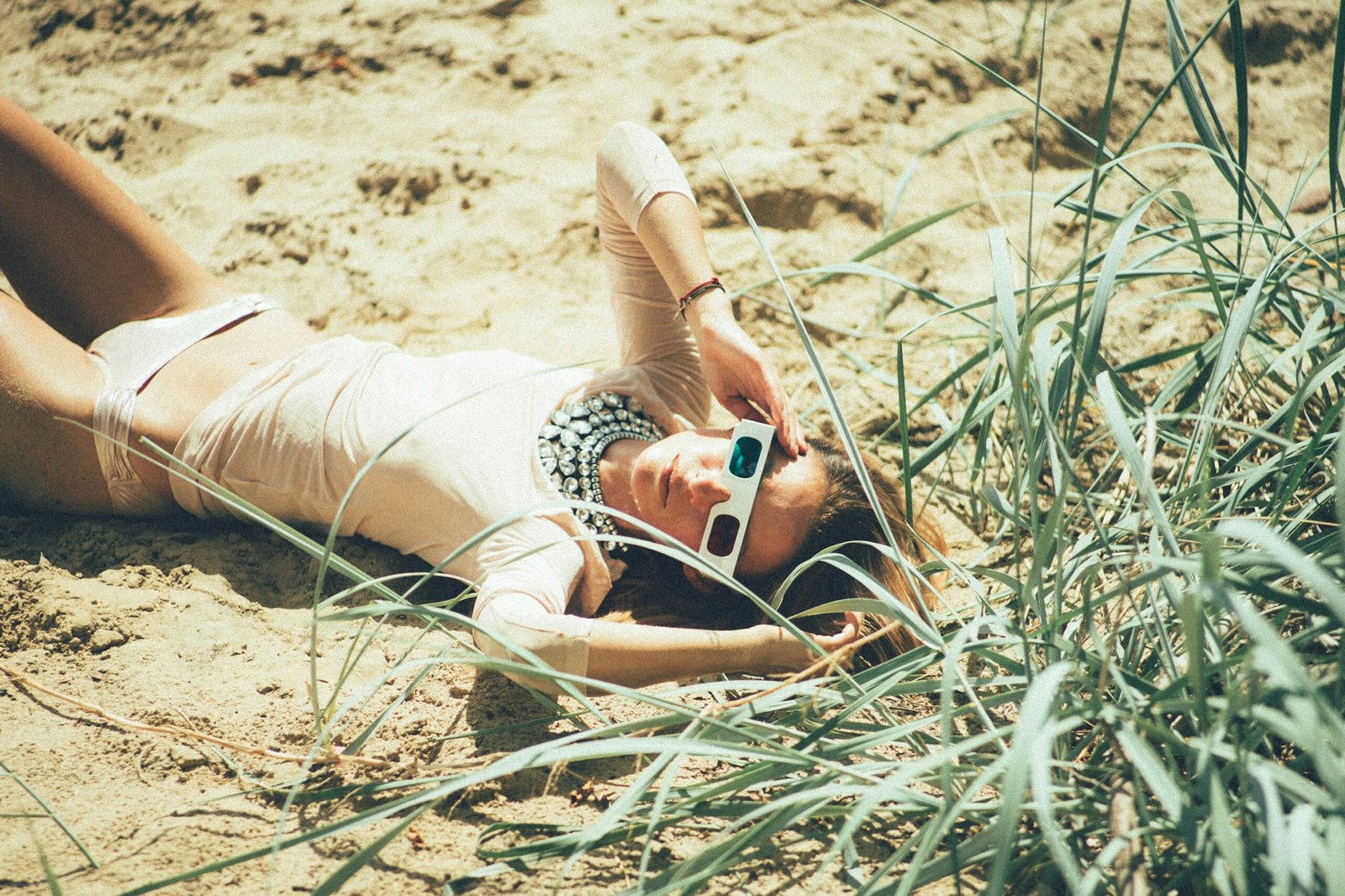 woman lying near green grass