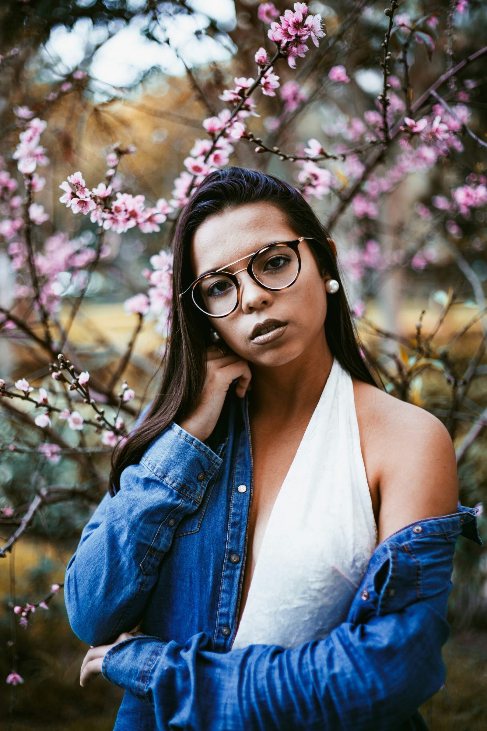 woman standing in front of blossom trees